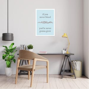 May include: A light blue background with the text "if you never bleed you're never gonna grow" in grey text. The text is separated by a line of small, grey, stylized hearts.