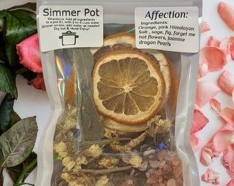 May include: A clear plastic bag filled with dried orange slices, pink Himalayan salt, sage, fig, forget-me-not flowers, jasmine, and dragon pearls. The bag has a label that reads "Simmer Pot" and "Affection: Ingredients: Orange, pink Himalayan Salt, sage, fig, forget me not flowers, jasmine dragon Pearls".