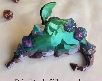 May include: A green and purple 3D-printed dragon-shaped dice holder with several multi-sided dice. The dice are purple and blue with gold numbering. The text "Digital file only" is at the bottom.