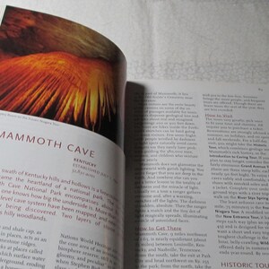 May include: An open book displaying a colourful image of a cave formation, possibly Mammoth Cave. The text reads "Mammoth Cave, Kentucky." The page also contains descriptive text about the cave system.