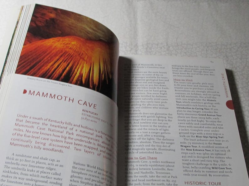 May include: An open book displaying a colourful image of a cave formation, possibly Mammoth Cave. The text reads "Mammoth Cave, Kentucky." The page also contains descriptive text about the cave system.