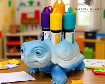 May include: A light blue turtle-shaped essential oil holder with a white belly. It holds several essential oil bottles with colorful lids. The holder is on a wooden surface with colorful markers and a piece of paper.