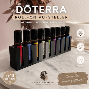 Könnte beinhalten: Ein schwarzer, rechteckiger 3D-gedruckter Ständer für zehn ätherische Öl-Roll-on-Fläschchen. Der Ständer verfügt über zehn einzelne Fächer, die jeweils ein dunkles Glasfläschchen mit farbigem Etikett enthalten, darunter Rose, Peppermint, Helichrysum, Copaiba, Tea Tree und Serenity.