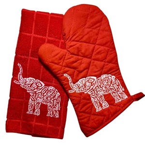 May include: Red quilted oven mitt and matching kitchen towel with white embroidered elephant designs.