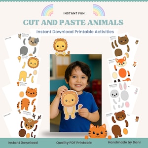 May include: A child holds a lion cutout from a 'Cut and Paste Animals' printable activity. The image features various animal cutouts, including a dog, tiger, fox, bunny, and bear. Text includes 'Instant Fun' and 'Instant Download Printable Activities'.
