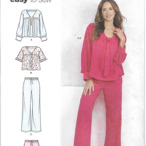 May include: Simplicity sewing pattern S9928, featuring a woman in a pink pajama set. The pattern includes options for a top, pants, and shorts. The text "easy-to-sew" is displayed. The pattern is designed and printed in the USA.