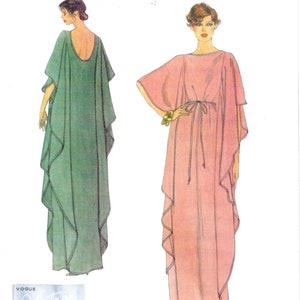 May include: Vogue Patterns sewing pattern featuring two flowing caftan dresses. One is a soft green, the other a light pink. The pattern is a reissue from 1979, with the text "Vogue Vintage Model" and "Designed and printed in the USA."