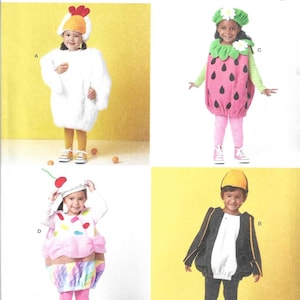 May include: Simplicity S3060 sewing pattern for children's costumes in size 1/2-4. The pattern features four designs: a white chicken, a strawberry with a green hat, a cupcake with a cherry topper, and a black and white penguin costume.