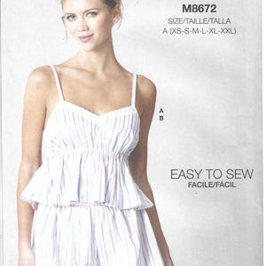 May include: McCall's sewing pattern M8672 for a two-piece set featuring a camisole top with thin straps and a ruffled peplum waist, paired with matching shorts. The fabric has a vertical stripe pattern in light blue, pink, and white colors.
