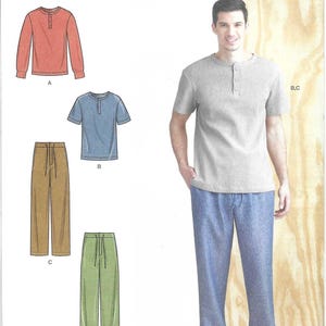 May include: Simplicity sewing pattern S9315 featuring a man's outfit. The pattern includes a short-sleeved gray Henley shirt and blue pants. Also shown are a long-sleeved orange shirt, a blue short-sleeved shirt, and brown and green pants.