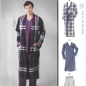 May include: McCall's sewing pattern M8443 featuring a plaid robe, pajama top, and shorts. The model is wearing a purple, black, and white plaid robe and pajama set. The pattern includes multiple view options with simple instructions.
