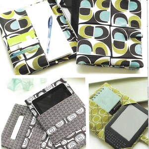 May include: A fabric tech portfolio and pocket set featuring geometric patterns in olive green, teal, and dark brown. The portfolio includes interior slots for cards and a pen, while the tech pocket holds an e-reader. Text reads Indygo Junction by Amy Barickman and Tech Pocket & Portfolio IJ904.