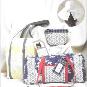 May include: A collection of Laura Ashley fabric accessories, including a tote bag with yellow floral print, a duffel bag with blue floral print, a small pouch, and a sun hat. The bags have gray and red straps.