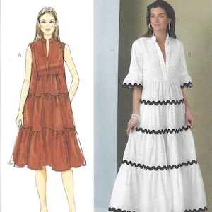 May include: A sewing pattern from Butterick, featuring two dress designs. One is a sleeveless, tiered dress in a rust color. The other is a white, long-sleeved dress with black scalloped trim. The pattern number is B6993.