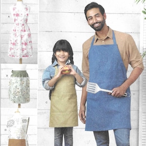 May include: Simplicity sewing pattern featuring aprons. The image shows a man and a child wearing aprons, with examples of apron designs on the left. The aprons are in blue and tan colors. The pattern includes sizes S-XL.