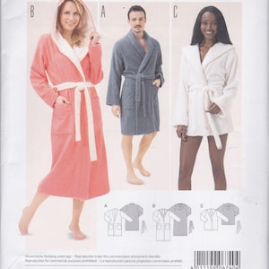 May include: A sewing pattern for bathrobes. The pattern features three different bathrobe styles in various sizes. The image shows a woman in a coral robe, a man in a gray robe, and a woman in a white robe. The text "burda style" is at the top.