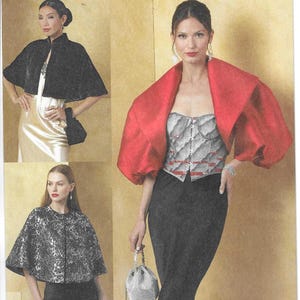 May include: Vogue Patterns V2078. The image shows a pattern for capes and a corset top. The capes are black, silver, and red. The corset top is silver with red accents. The pattern is designed and printed in the USA.