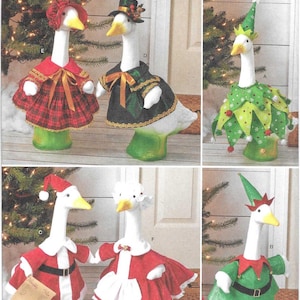 May include: A Simplicity S3187 sewing pattern envelope featuring six white goose figurines dressed in various holiday outfits, including a plaid dress, a green coat, a green elf costume, a Santa suit, a white apron dress, and a green elf tunic.