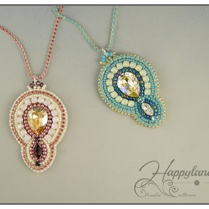 May include: Two beaded necklaces with crystal pendants. The necklace on the left has a pink and gold pendant with a teardrop-shaped crystal. The necklace on the right has a blue and green pendant with a teardrop-shaped crystal.