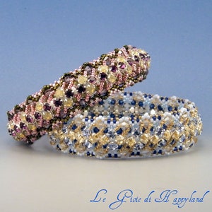 May include: Two beaded bracelets, one with pink, purple, and gold beads, and the other with blue, white, and gold beads. The bracelets are stacked on top of each other.