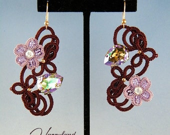May include: A pair of brown and purple earrings with a flower and crystal design. The earrings are made with a delicate, intricate knotting technique.