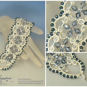 May include: A delicate bracelet made with white and blue beads, featuring a snowflake design. The bracelet is made with a variety of beads, including seed beads, crystals, and pearls. The bracelet is finished with a silver clasp.