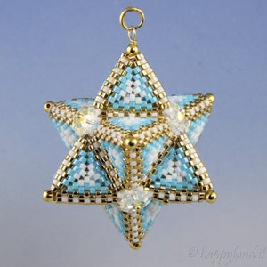 May include: A gold and blue beaded star ornament with clear crystal accents. The star is 3-dimensional and has a loop at the top for hanging.