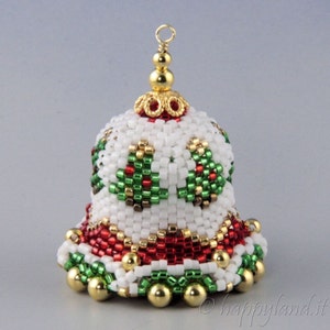 May include: A white beaded Christmas bell ornament with red and green accents. The bell has a gold top and a gold bead trim.