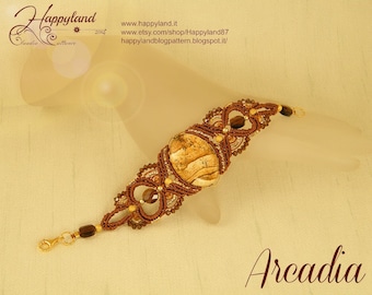 May include: A brown and gold macrame bracelet with a large, round, brown and white agate stone in the center. The bracelet is decorated with small, clear crystals. The bracelet is called "Arcadia".