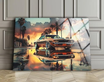 May include: A classic brown and white muscle car with a chrome bumper and black wheels is parked in front of a sunset backdrop with palm trees. The car is reflected in a puddle of water on the asphalt.