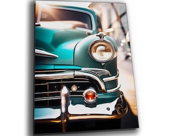 May include: Close-up of a teal vintage car with chrome accents. The car's headlight is illuminated, and the sun is shining brightly in the background.