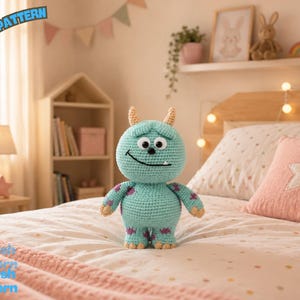 May include: A light blue crochet monster plush toy with two small horns, two round black eyes, and a single white tooth. The creature features purple spots on its arms and legs. The text PDF PATTERN is visible in the top left corner.