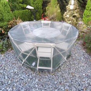 May include: A clear plastic cover for a round patio table and chairs. The cover is made of a durable, waterproof material and is designed to protect your furniture from the elements.