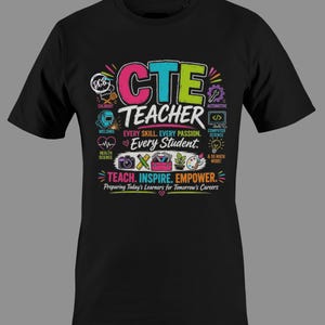 May include: A black t-shirt featuring a colorful graphic with the text CTE TEACHER, EVERY SKILL. EVERY PASSION. Every Student. TEACH. INSPIRE. EMPOWER. Preparing Today's Learners for Tomorrow's Careers, surrounded by icons for various trades.