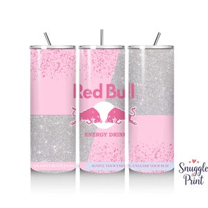 May include: Three pink and silver glitter tumbler cups with a Red Bull logo and the text "Energy Drink" on the middle cup. The text on the left cup reads "Naughty Bitch Energy" and the text on the right cup reads "Ignite Your Energy, Unleash Your Slay".