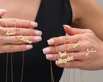 May include: A close-up of a hand holding several gold necklaces with personalized names, including "Sophia", "Olivia", "Summer", "Besa", "Augustine", and "Zehra".