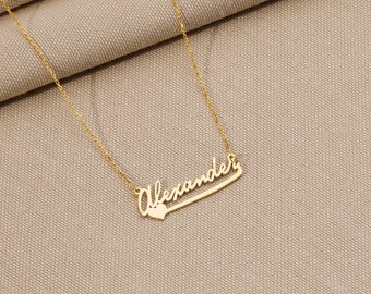 May include: A gold necklace with the name "Alexander" written in cursive with a small heart at the end.