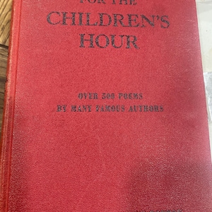 May include: A red hardcover book titled "POEMS FOR THE CHILDREN'S HOUR" with black lettering. The book cover also states "OVER 500 POEMS BY MANY FAMOUS AUTHORS" and "COMPILED BY JOSEPHINE BOUTON".