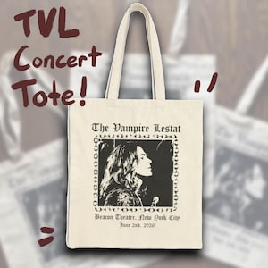 May include: A cream-colored canvas tote bag featuring a black graphic print of a person in profile. The text reads The Vampire Lestat, Beacon Theatre, New York City, and June 2nd, 2026. The bag has two shoulder straps and a rectangular body shape.