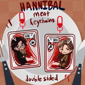 May include: Two square acrylic keychains with red plastic clasps, each featuring a cartoon character inside a red meat-shaped frame. One keychain shows a character with a cat, the other a character with a dog. Text reads HANNIBAL meat Keychains double sided.