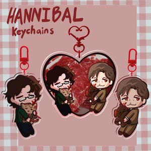 May include: Three acrylic keychains featuring cartoon characters with blood splatters. One is heart-shaped with two characters holding plushies. The others are individual characters holding plushies. All have red heart-shaped clasps and text HANNIBAL Keychains.