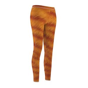 May include: Leggings featuring a striking orange and brown fur-like design. These high-waisted, slim-fit leggings have a white elastic waistband. The pattern gives the appearance of animal fur.