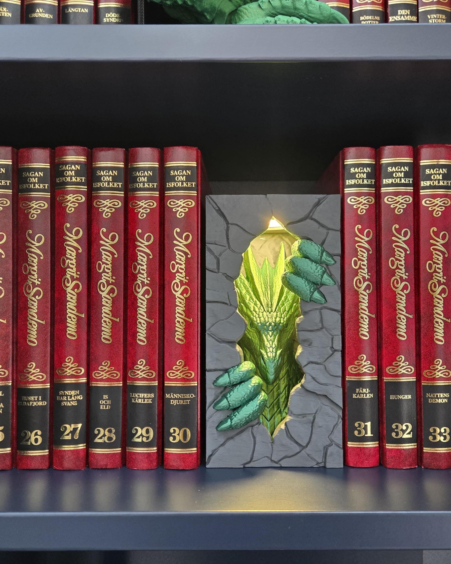 A dragon-themed book nook night light with LED puck, featuring a fantasy shelf lamp with a green dragon head and claw design.