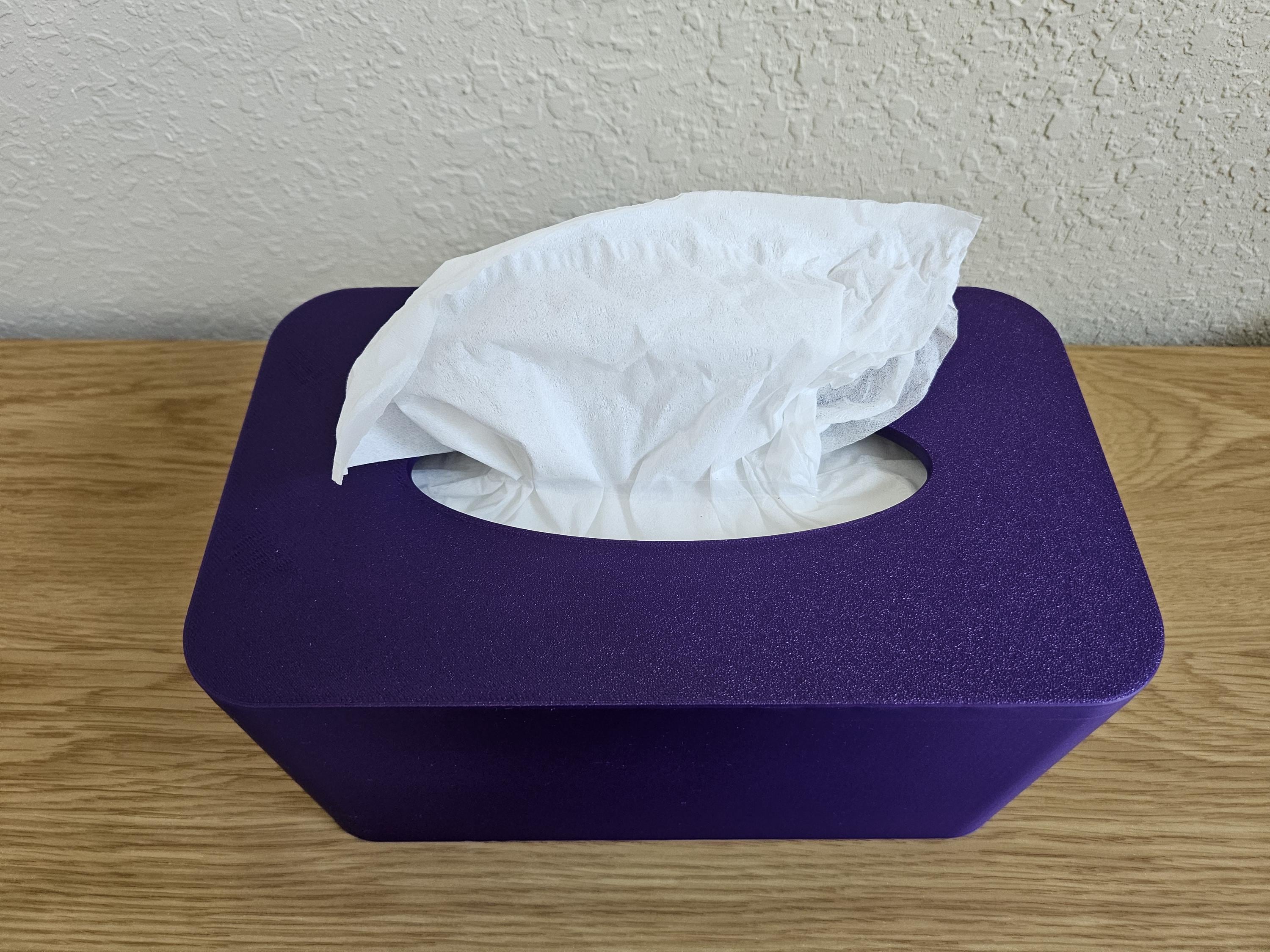 A modern tissue box cover in a vibrant purple color, featuring a cut-out for easy access to tissues.