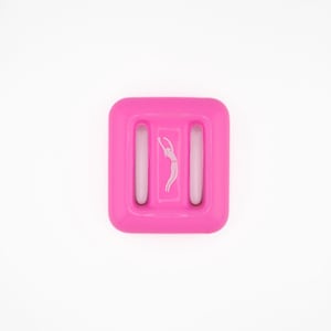 May include: A bright pink, square-shaped weight with a white graphic of a person in a dancing pose. The weight has two vertical rectangular openings and is designed for aquatic exercise.