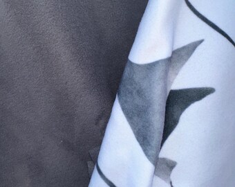 May include: Two pieces of fabric, one dark gray and one white with a black and gray abstract design.