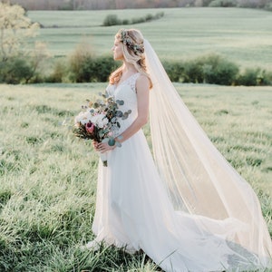 Beautiful soft English net veil in cathedral length. Light Ivory is featured here.