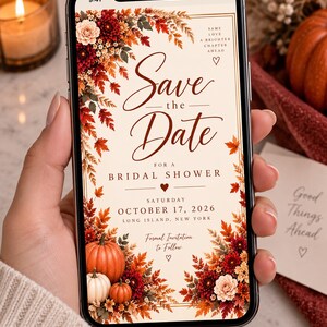 May include: A smartphone displaying a digital Save the Date bridal shower invitation with autumn floral accents, including red and orange leaves, pumpkins, and flowers. The text reads: Save the Date for a Bridal Shower, Saturday October 17, 2026.