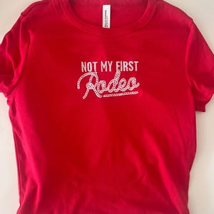 初めてのロデオ刺繍ベビーTシャツ - レトロウエスタンY2Kシャツ、レッドカウガールクロップTシャツ、ロデオ風トップス、カスタムギフト
