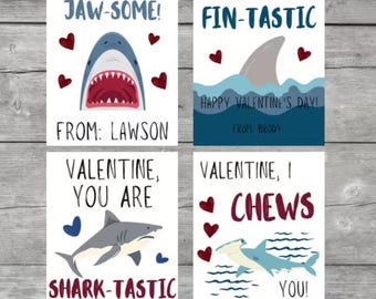 May include: Four Valentine's Day cards featuring shark illustrations and puns. The cards are printed on white cardstock with red and blue accents. The text on the cards reads: "I think you are jaw-some!"  "You are fin-tastic!"  "Valentine, you are shark-tastic!"  "Valentine, I chews you!"